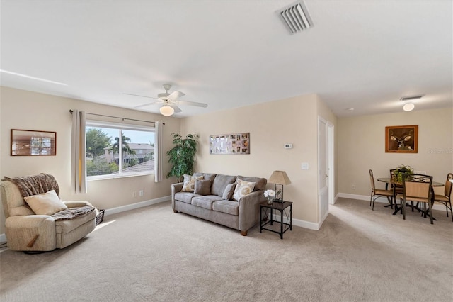 carpeted living room featuring ceiling fan