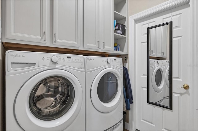 laundry area featuring cabinets and washer and clothes dryer