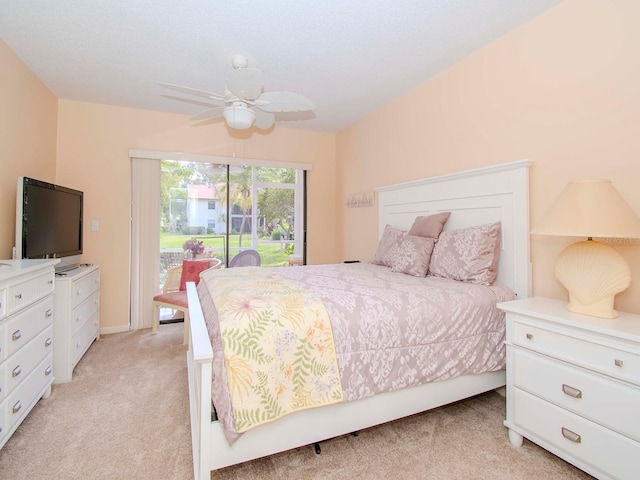 bedroom with light colored carpet, ceiling fan, and access to outside