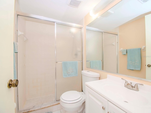 bathroom featuring a shower with shower door, vanity, toilet, and tile flooring