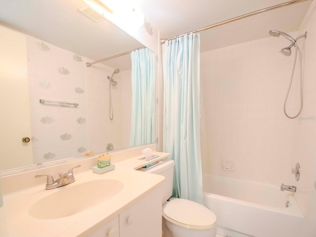 full bathroom featuring toilet, shower / bath combination with curtain, and vanity