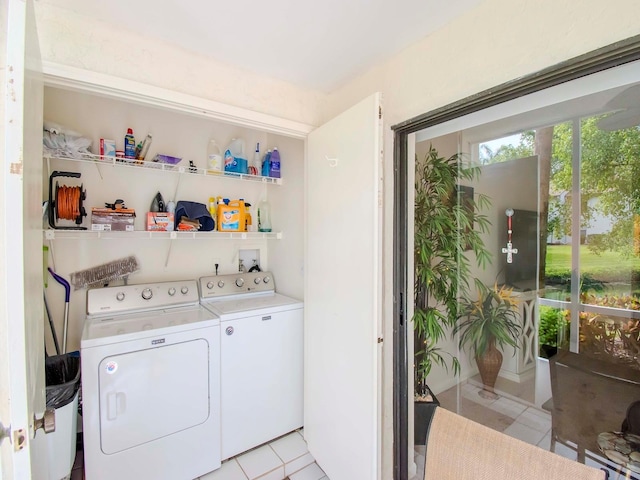 laundry room featuring washing machine and dryer, light tile floors, and washer hookup