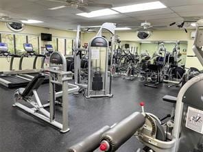 workout area featuring a drop ceiling and ceiling fan