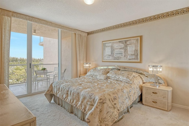 bedroom with light colored carpet, a textured ceiling, and access to outside