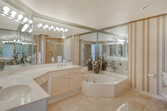 bathroom with tile flooring, large vanity, double sink, toilet, and a bathtub