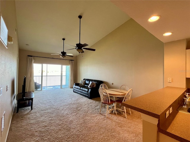 living room featuring high vaulted ceiling, carpet floors, and ceiling fan