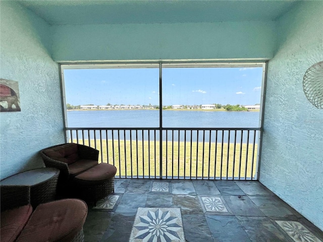 sunroom with a water view and plenty of natural light