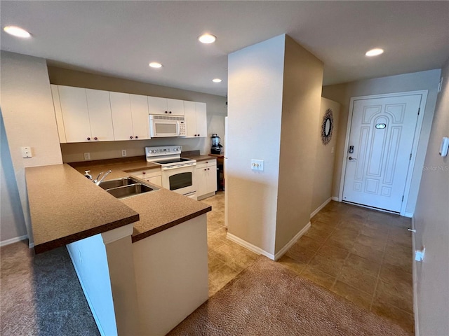 kitchen with white cabinets, light tile floors, kitchen peninsula, white appliances, and sink