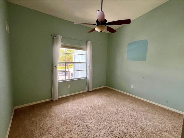 carpeted empty room featuring ceiling fan