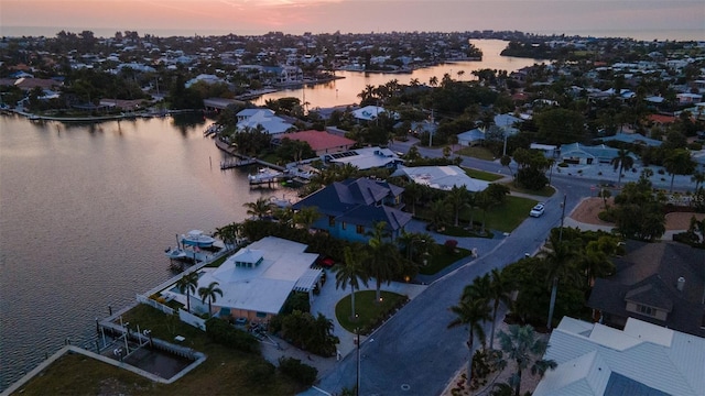 aerial view at dusk with a water view