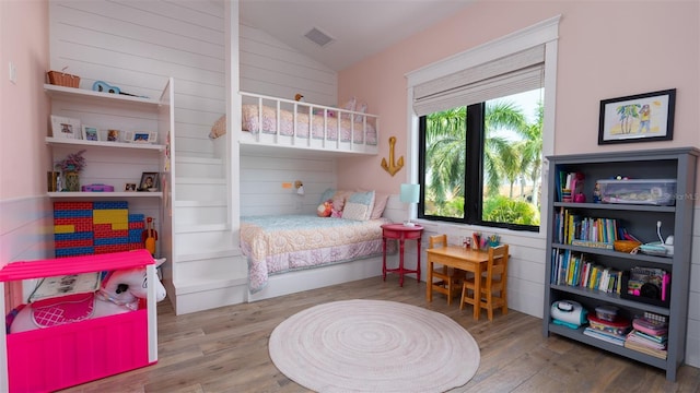 bedroom with hardwood / wood-style flooring and vaulted ceiling