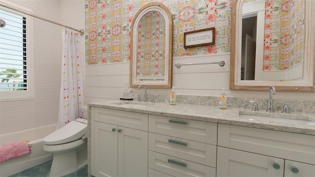 full bathroom featuring wooden walls, shower / bath combo with shower curtain, vanity, and toilet