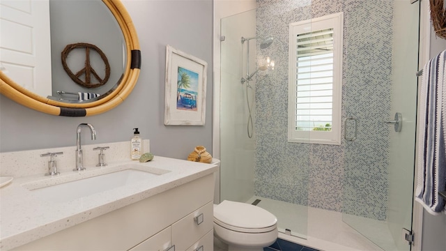 bathroom with tile patterned flooring, vanity, an enclosed shower, and toilet