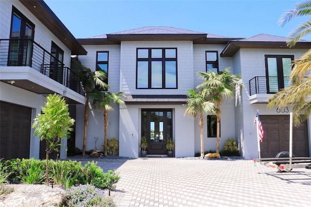 view of front of house featuring french doors and a balcony