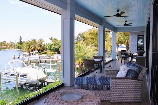 exterior space with ceiling fan and a water view