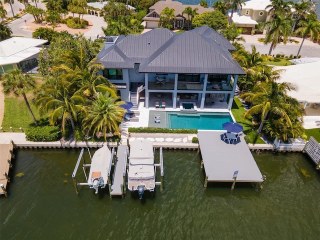 exterior space featuring a water view, ceiling fan, and a patio area