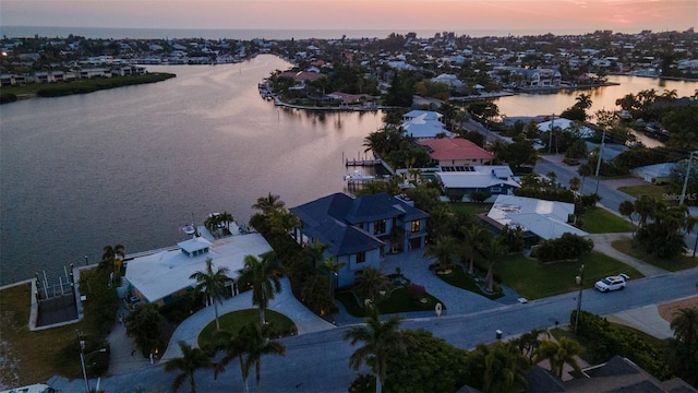 aerial view at dusk with a water view