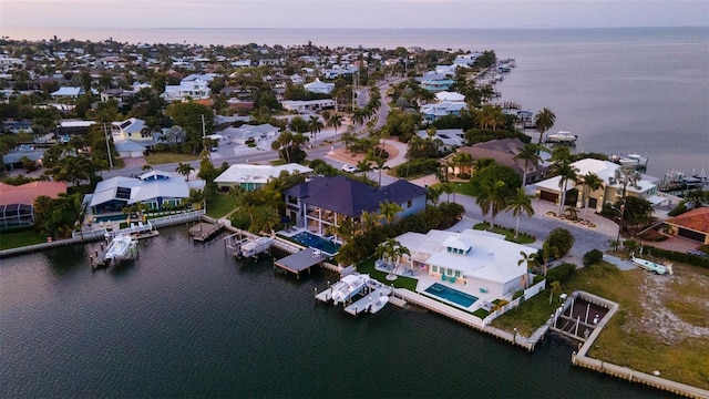 aerial view at dusk with a water view