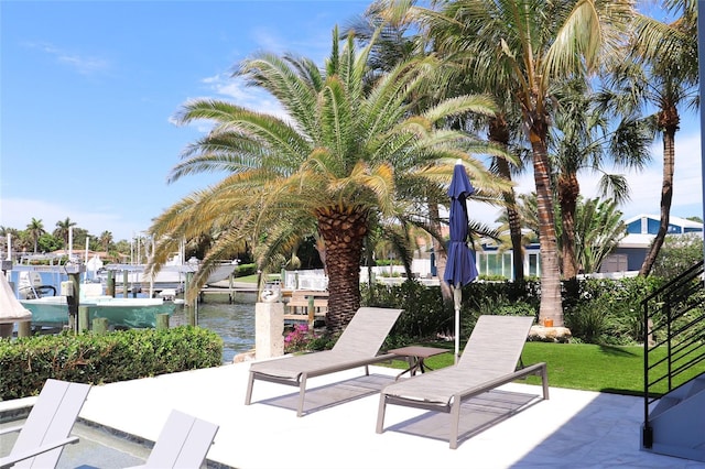 view of home's community with a yard and a water view