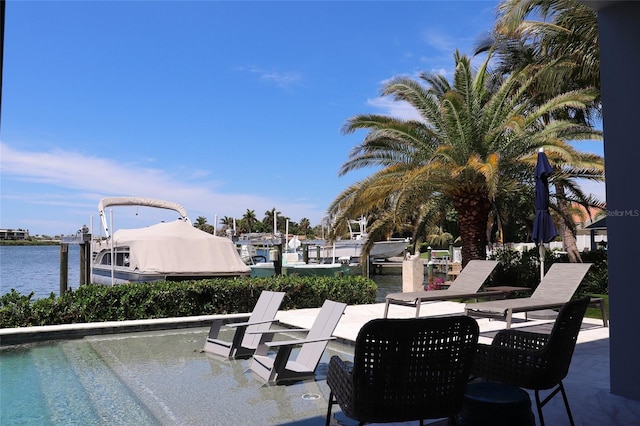 view of patio with a dock and a water view