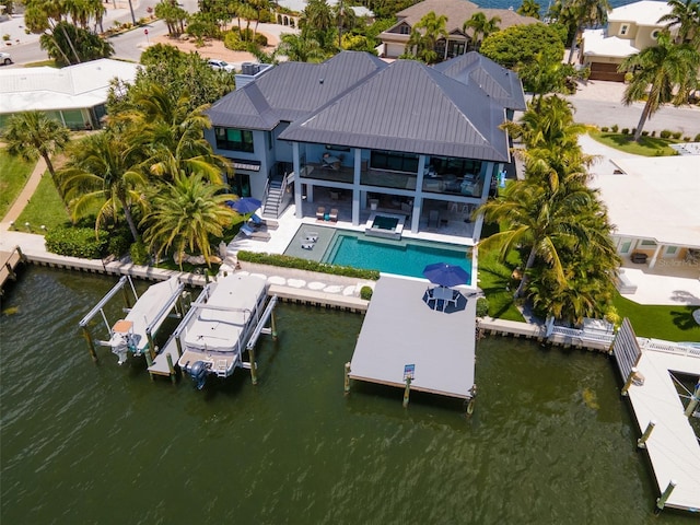 exterior space with a balcony, a water view, and a patio