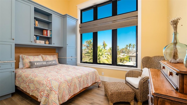 bedroom with dark hardwood / wood-style flooring