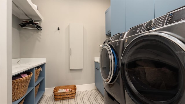 laundry area with washer and dryer and cabinets