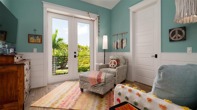 doorway with lofted ceiling, french doors, and light hardwood / wood-style flooring