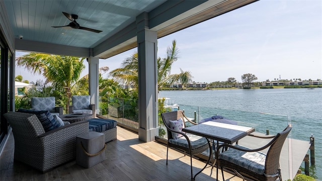 deck featuring ceiling fan, a water view, and an outdoor hangout area