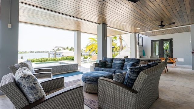 view of patio featuring ceiling fan, french doors, an outdoor living space, a swimming pool, and a water view