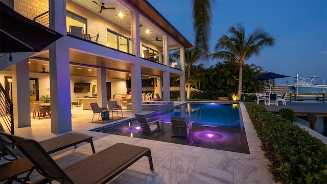 view of pool featuring a patio area, an in ground hot tub, ceiling fan, and an outdoor fireplace