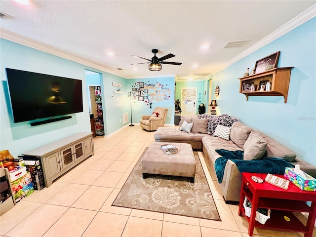 tiled living room with a textured ceiling, ceiling fan, and crown molding