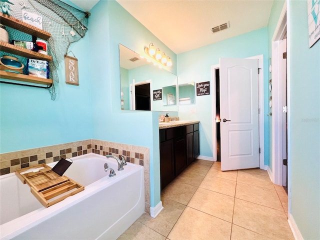 bathroom featuring vanity, a tub, and tile floors