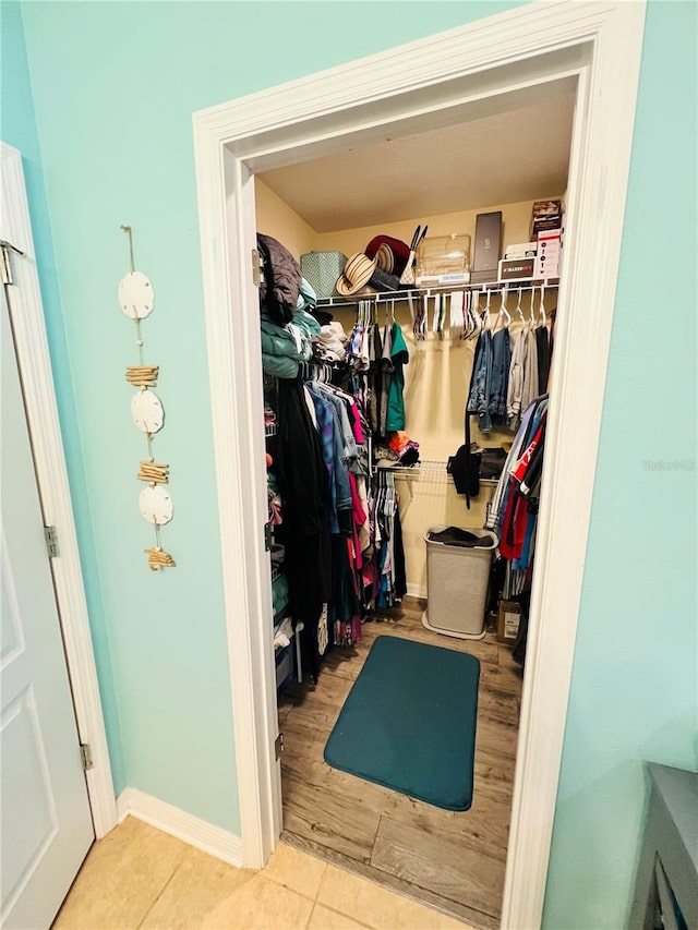 spacious closet with light tile floors