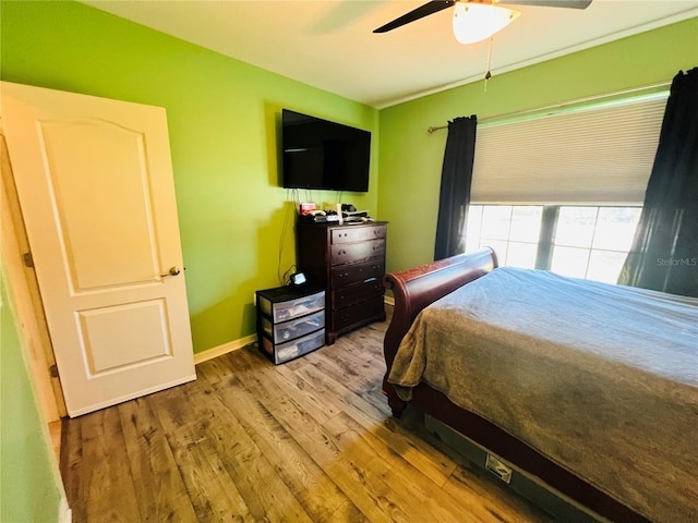 bedroom with ceiling fan and light wood-type flooring