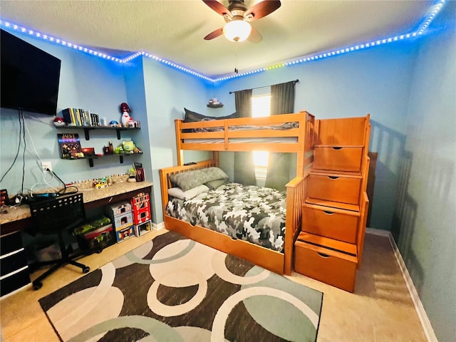 carpeted bedroom featuring a textured ceiling and ceiling fan