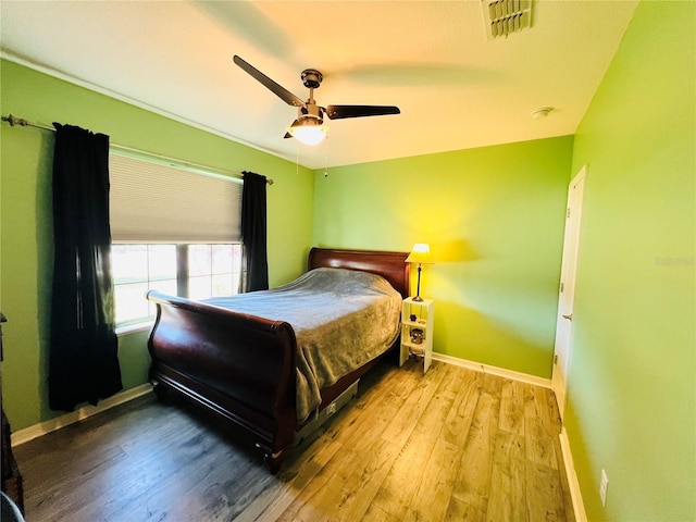 bedroom with wood-type flooring and ceiling fan