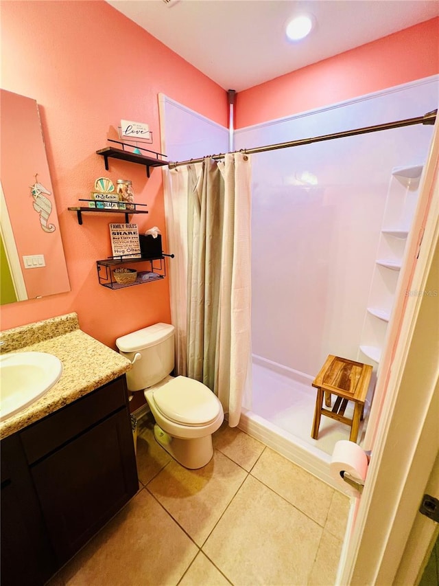 bathroom featuring a shower with shower curtain, vanity, tile floors, and toilet