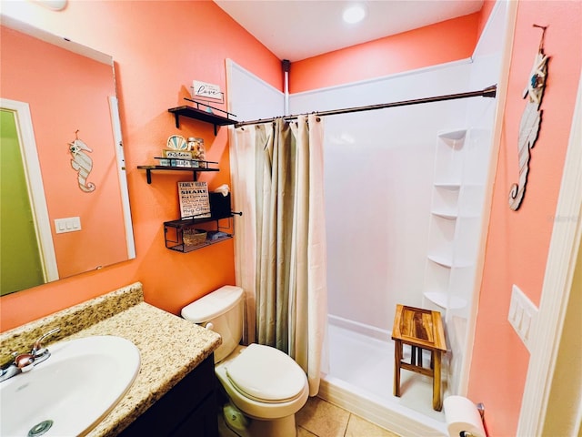 bathroom with vanity, tile floors, and toilet