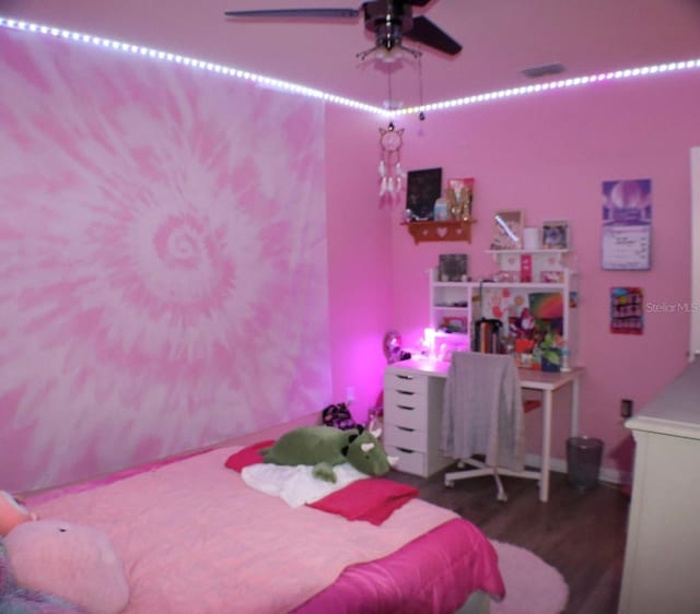 bedroom with ceiling fan and dark wood-type flooring