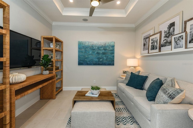 tiled living room featuring ceiling fan, ornamental molding, and a tray ceiling