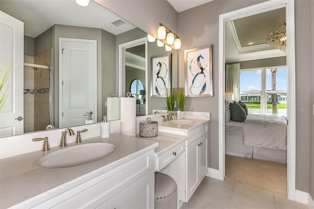 bathroom featuring tile patterned flooring, vanity, a shower with door, and ornamental molding