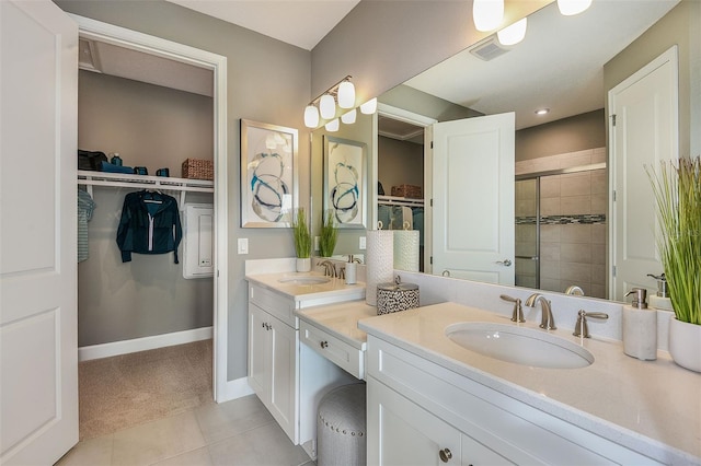 bathroom featuring tile patterned flooring, vanity, and an enclosed shower