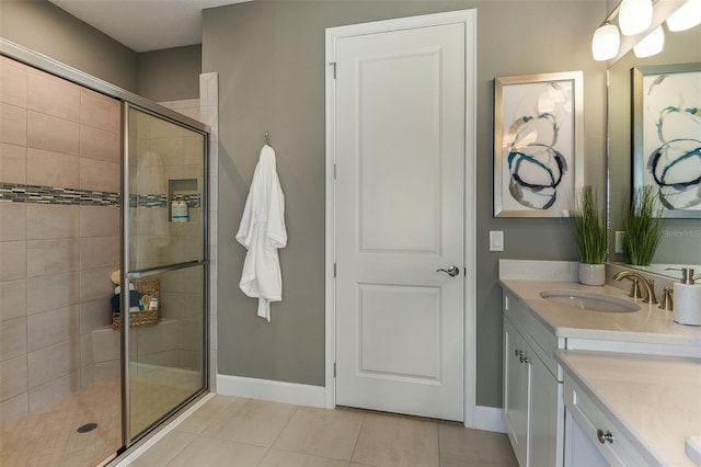 bathroom featuring tile patterned floors, vanity, and an enclosed shower