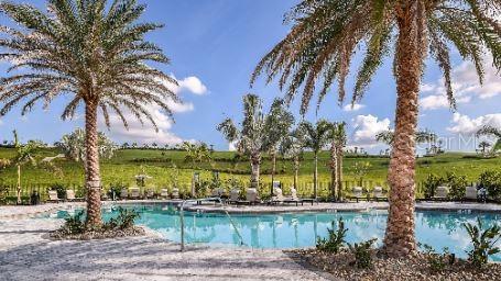 view of swimming pool with a rural view