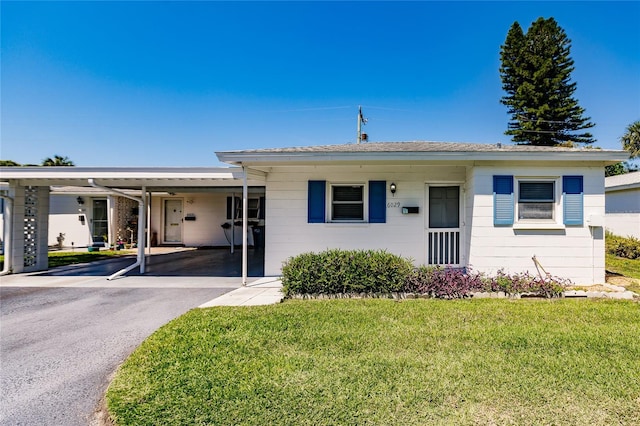 ranch-style home with a carport and a front lawn