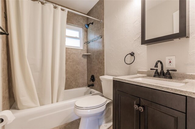 full bathroom with vanity with extensive cabinet space, toilet, and shower / tub combo with curtain