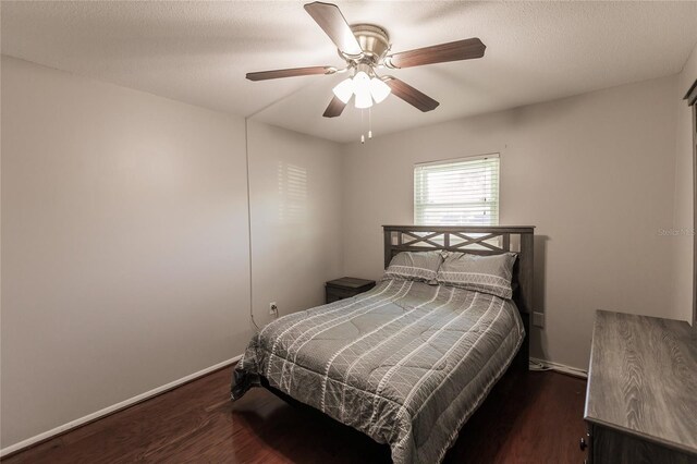 bedroom featuring ceiling fan and dark hardwood / wood-style floors