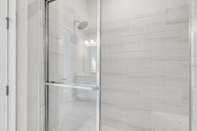 bathroom with a shower with shower door