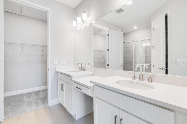 bathroom with vanity and a shower with shower door